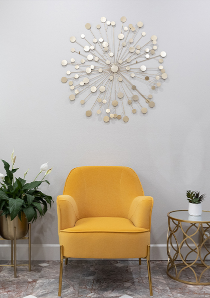 Yellow armchair against white wall