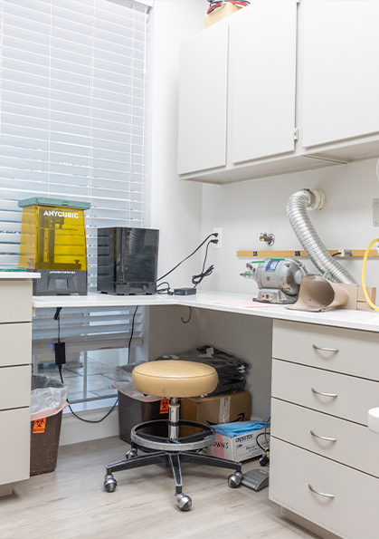 White table and cabinets containing advanced dental technology