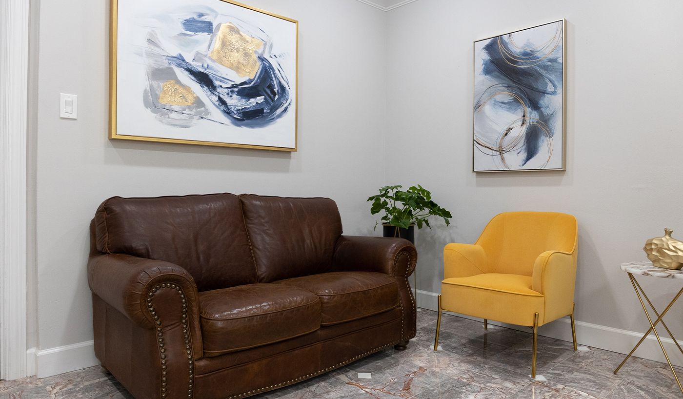 Yellow armchair next to brown leather couch in Dallas dental office