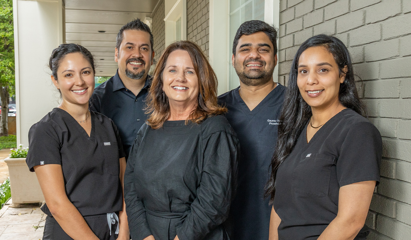 Smiling Dallas dental team standing in front of Luminescence Dentistry