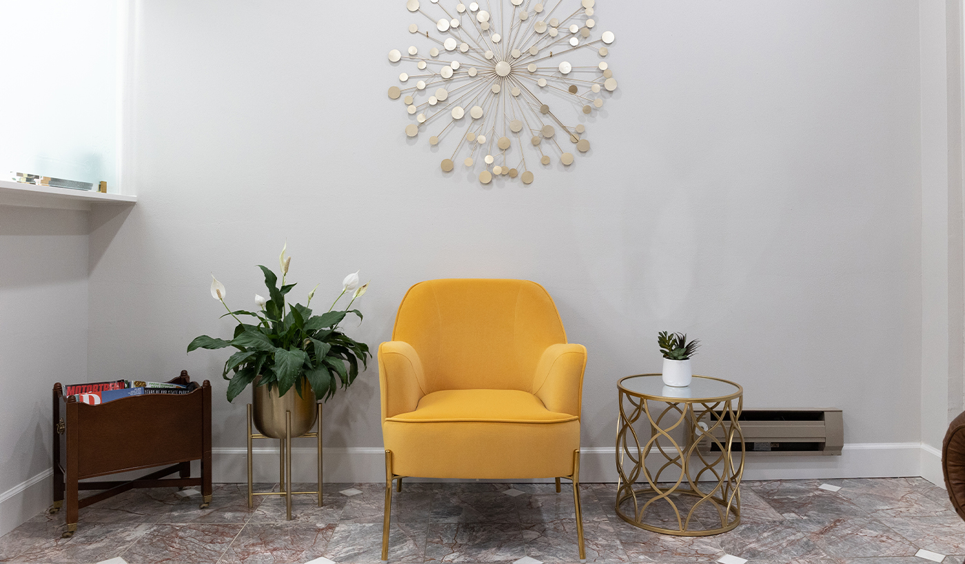 Yellow armchair against white wall in Dallas dental office