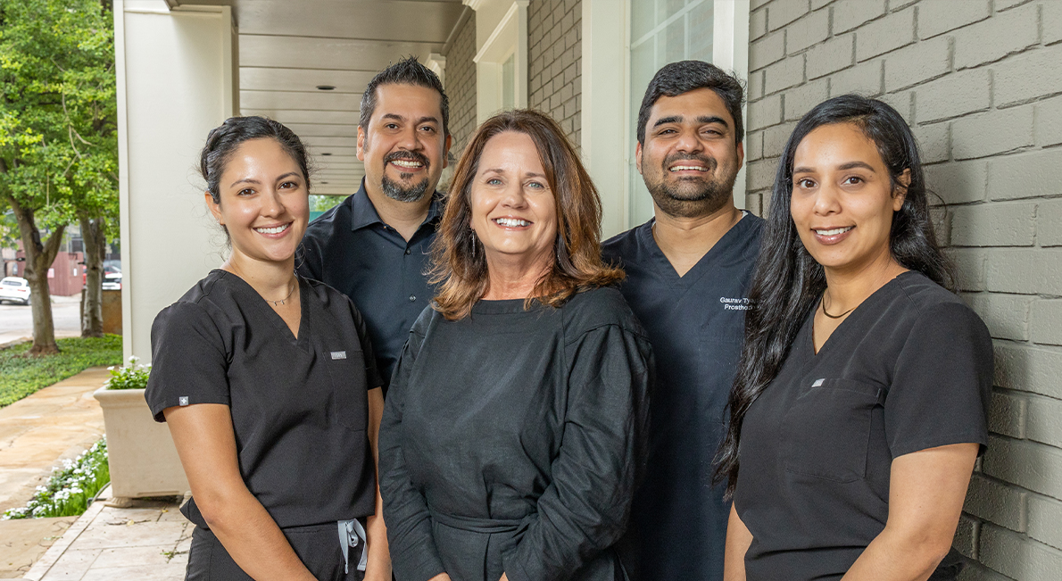 Luminescence Dentistry team members smiling outside of dental office in Dallas
