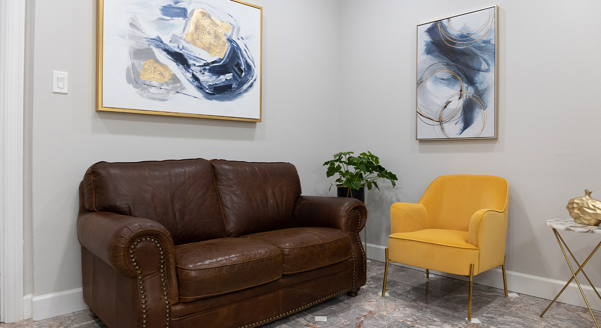 Yellow armchair next to brown leather couch