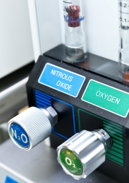 Button labeled nitrous oxide next to button labeled oxygen on nitrous oxide sedation dentistry machine
