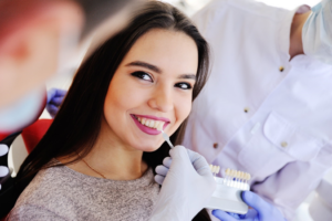 a person smiling while receiving veneers